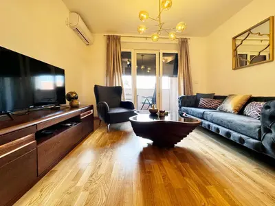 a living room with a couch and a tv at Apartman My Dream in Vrnjačka Banja