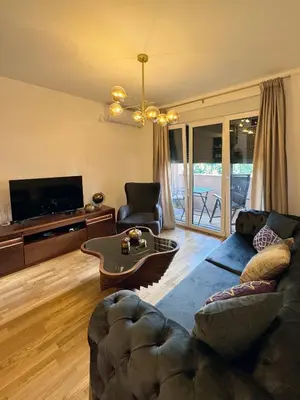 a living room with a couch and a table at Apartman My Dream in Vrnjačka Banja