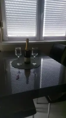 a table with two glasses and a bottle of wine at Sofi in Jagodina