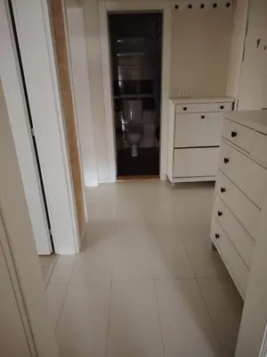 a white kitchen with a sink and a toilet at Sofi in Jagodina