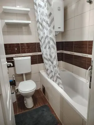 a bathroom with a toilet and a shower curtain at Sofi in Jagodina