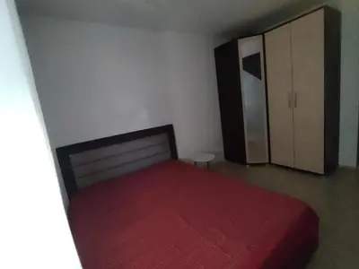 a bedroom with a bed with a red blanket at Sofi in Jagodina