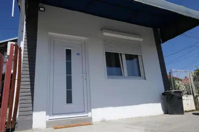 a white door and a window on a house at Apartman Dzunic in Pirot
