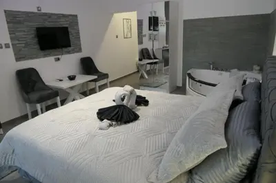 a stuffed animal sitting on top of a bed at Apartman Dzunic in Pirot