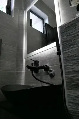 a bathroom with a sink and a mirror at Apartman Dzunic in Pirot