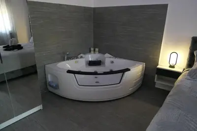 a bathroom with a white tub in a room at Apartman Dzunic in Pirot