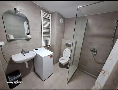 a bathroom with a sink toilet and a shower at Apartman Centrala Lux in Pirot