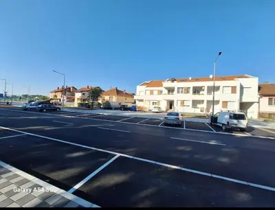 an empty parking lot with cars parked on the street at Apartman Centrala Lux in Pirot