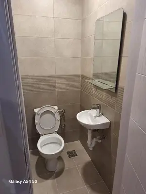 a small bathroom with a toilet and a sink at Apartman Centrala Lux in Pirot
