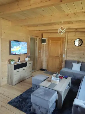 a living room with a couch and a tv at Kuća Pored Sunca in Kruševac