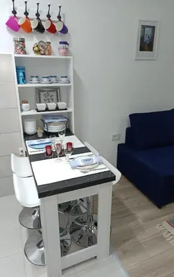 a table in a living room with a blue couch at AquaBlue Jagodina in Jagodina