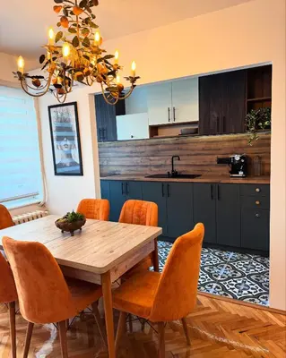 a kitchen with a wooden table and orange chairs at spazio in Knjazevac.