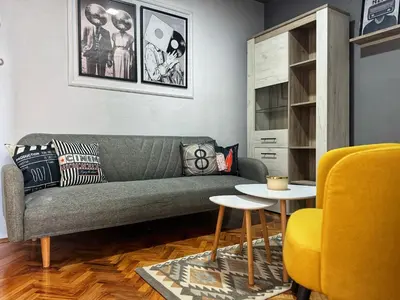 a living room with a green couch and a yellow chair at spazio in Knjazevac.