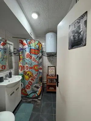 a bathroom with a sink and a shower curtain at spazio in Knjazevac.