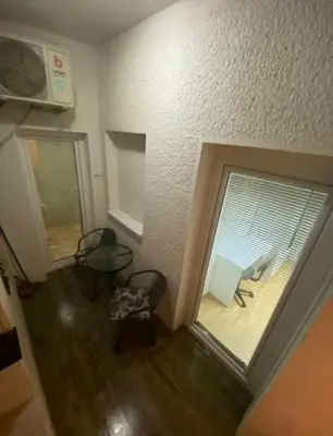 a room with two chairs and a large window at Lola Jagodina in Jagodina