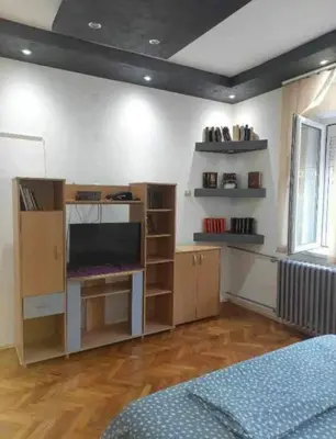 a room with a tv and shelves in a room at Lola Jagodina in Jagodina