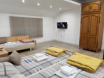 a room with two beds and a dresser at Kej apartman 2 duplex in Paraćin
