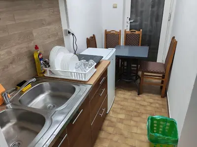 a small kitchen with a sink and a table at Kej apartman 2 duplex in Paraćin