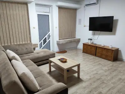 a living room with a couch and a tv at Kej apartman 2 duplex in Paraćin