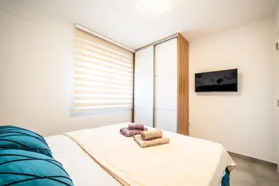 a bedroom with a bed with two towels on it at Todorović Lux Vrnjačka Banja in Vrnjačka Banja