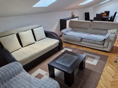 a living room with two couches and a coffee table at APARTMAN MiG in Vranje