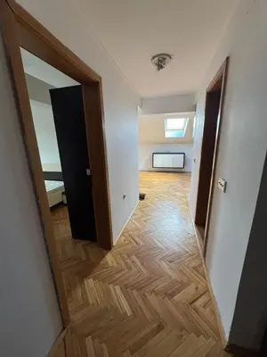 an empty room with a mirror and a hallway at APARTMAN MiG in Vranje
