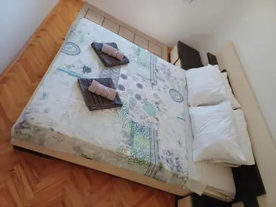 a bed with two pillows on top of it at APARTMAN MiG in Vranje