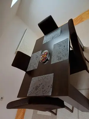 a wooden table with some papers on top of it at APARTMAN MiG in Vranje