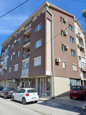 a large building with cars parked in front of it at STAN NA DAN MiG -Vranje in Vranje