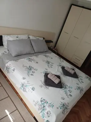 a bed with two towels and two shoes on it at STAN NA DAN MiG -Vranje in Vranje