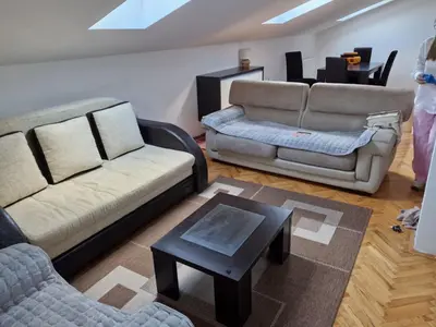 a living room with two couches and a coffee table at STAN NA DAN MiG -Vranje in Vranje