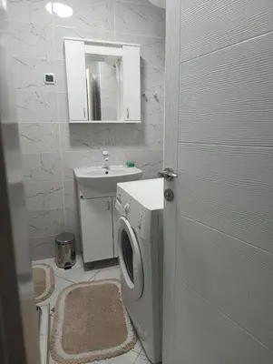 a bathroom with a washing machine and a sink at Doma Toma, Bela Palanka Town in Bela Palanka