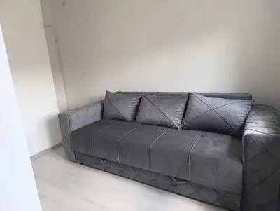 a brown leather couch sitting in a room at Doma Toma, Bela Palanka Town in Bela Palanka