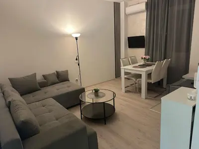 a living room with a couch and a table at Apt 2- Sokobanjica apartmani in Soko Banja