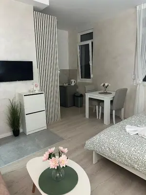 a living room with a couch and a table at Apt 7- Sokobanjica apartmani in Soko Banja