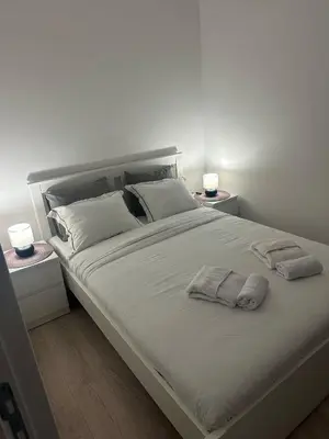 a large white bed with two pillows on it at Apt 6- Sokobanjica apartmani in Soko Banja