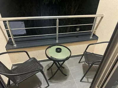 a table and chairs on a balcony with a ball on it at Apt 6- Sokobanjica apartmani in Soko Banja