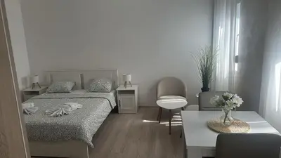 a small bedroom with a bed and a table at Apt 3- Sokobanjica apartmani in Soko Banja