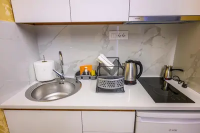 a kitchen counter top with a sink and a sink at Tanja Lux in Niš