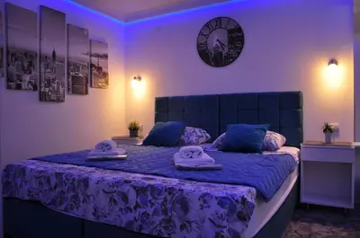 a bedroom with a bed with two masks on it at Your Place Studio in Niš