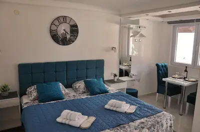 a bedroom with a blue bed with towels on it at Your Place Studio in Niš