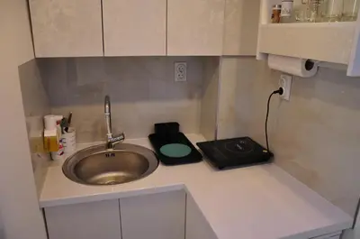 a kitchen counter with a sink and a scale at Your Place Studio in Niš