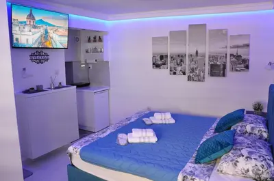 a bedroom with a blue bed with towels on it at Your Place Studio in Niš