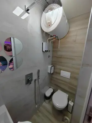 a bathroom with a white toilet and a sink at Your Place Studio in Niš