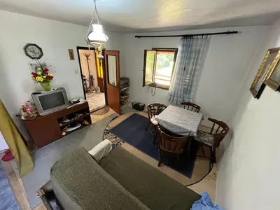 a living room with a couch and a table at Apartmani Radulovic in Kursumlijska Banja