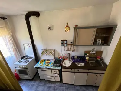 a small kitchen with a stove and a sink at Apartmani Radulovic in Kursumlijska Banja