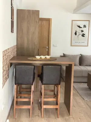 a dining room table with chairs and a couch at Snow Hill Kopaonik in Kopaonik