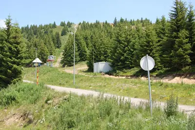 a street sign on the side of a road at Snow Hill Kopaonik in Kopaonik