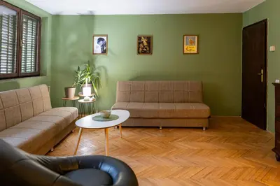 a living room with two couches and a table at City Centre Hostel in Niš