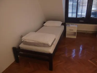 a small room with a bed and a window at City Centre Hostel in Niš